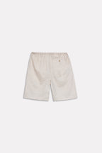 Texture and fabric detail, beige linen drawstring shorts, by SOLA Pakistan.