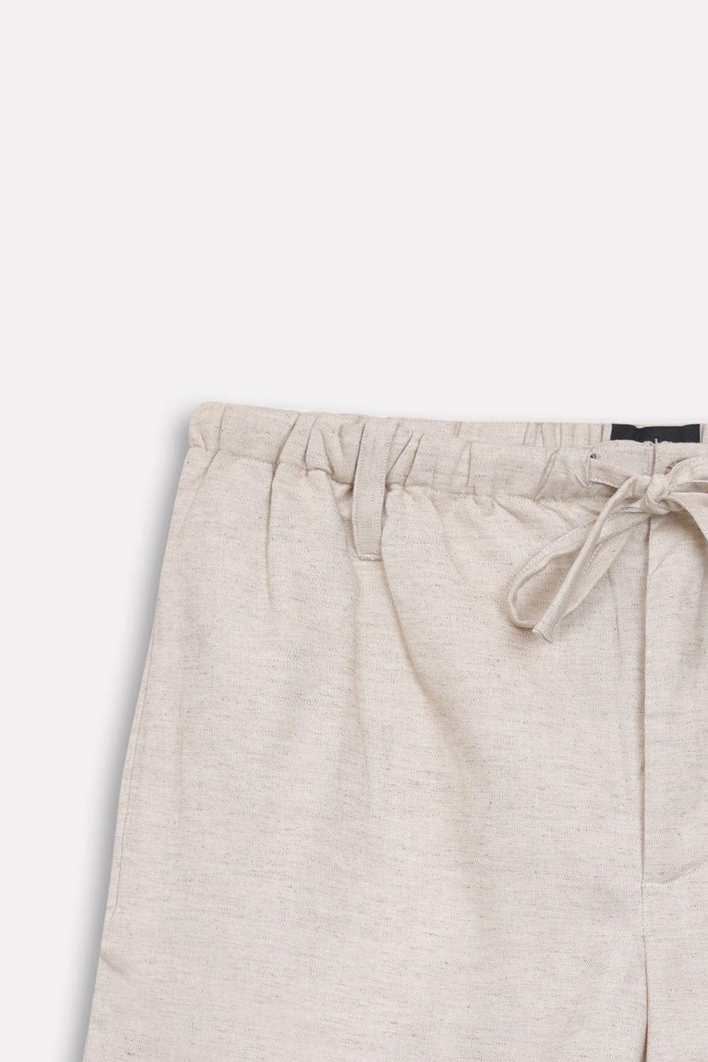Texture and fabric detail, beige linen drawstring shorts, by SOLA Pakistan.