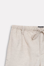 Texture and fabric detail, beige linen drawstring shorts, by SOLA Pakistan.