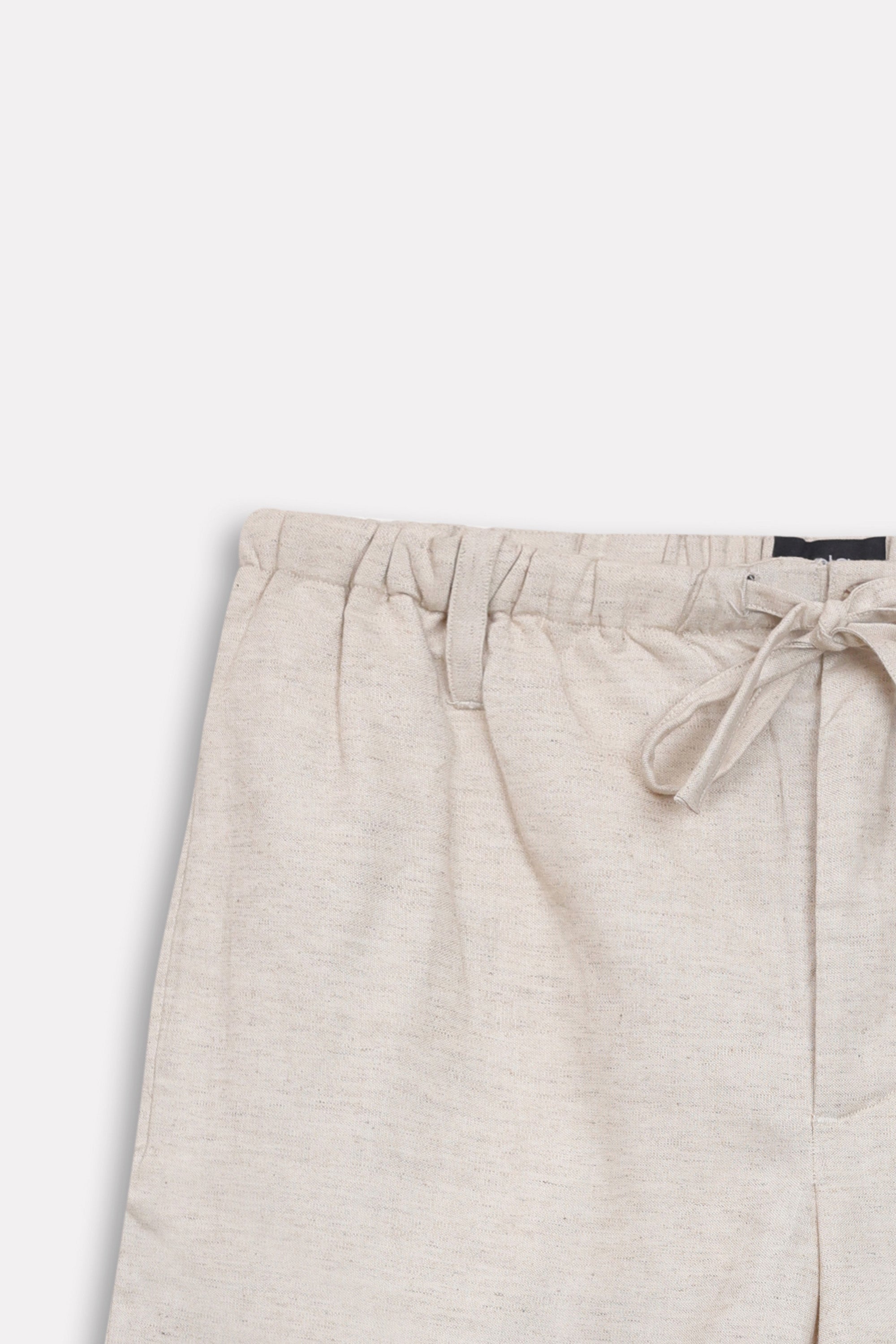Texture and fabric detail, beige linen drawstring shorts, by SOLA Pakistan.