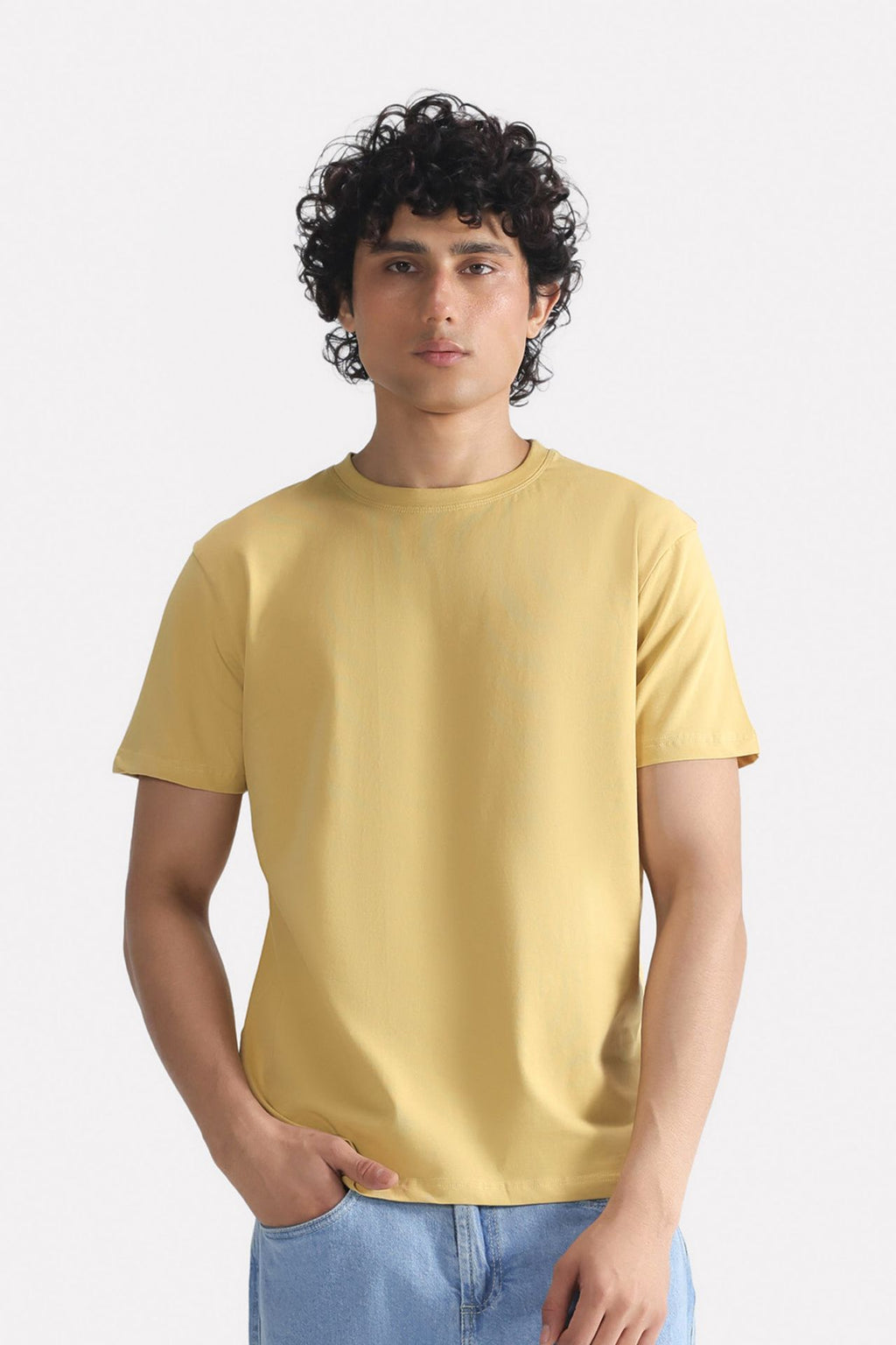 Beige regular fit crew neck t-shirt in cotton, worn by a model, by SOLA Pakistan.