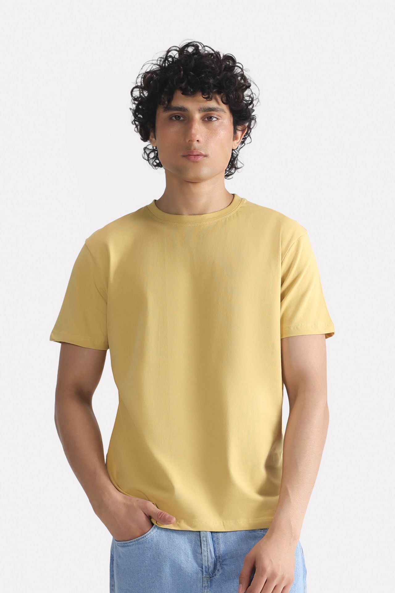 Beige regular fit crew neck t-shirt in cotton, worn by a model, by SOLA Pakistan.
