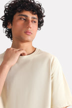 Beige (sand) drop shoulder cotton t-shirt shown in a styled fit, by SOLA Pakistan.