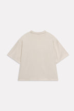Texture and fabric detail, beige (sand) drop shoulder cotton t-shirt, by SOLA Pakistan.