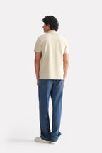 Beige (sand) micro-textured cotton pique polo, alternate angle, by SOLA Pakistan.
