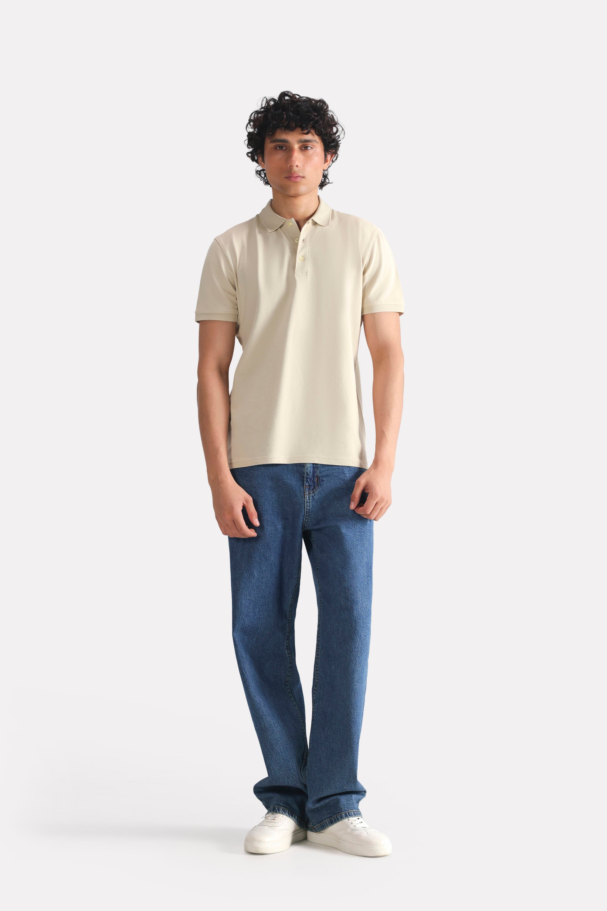 Close-up detail on the beige (sand) micro-textured cotton pique polo, by SOLA Pakistan.