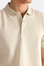 Flat lay of the beige (sand) micro-textured cotton pique polo, by SOLA Pakistan.