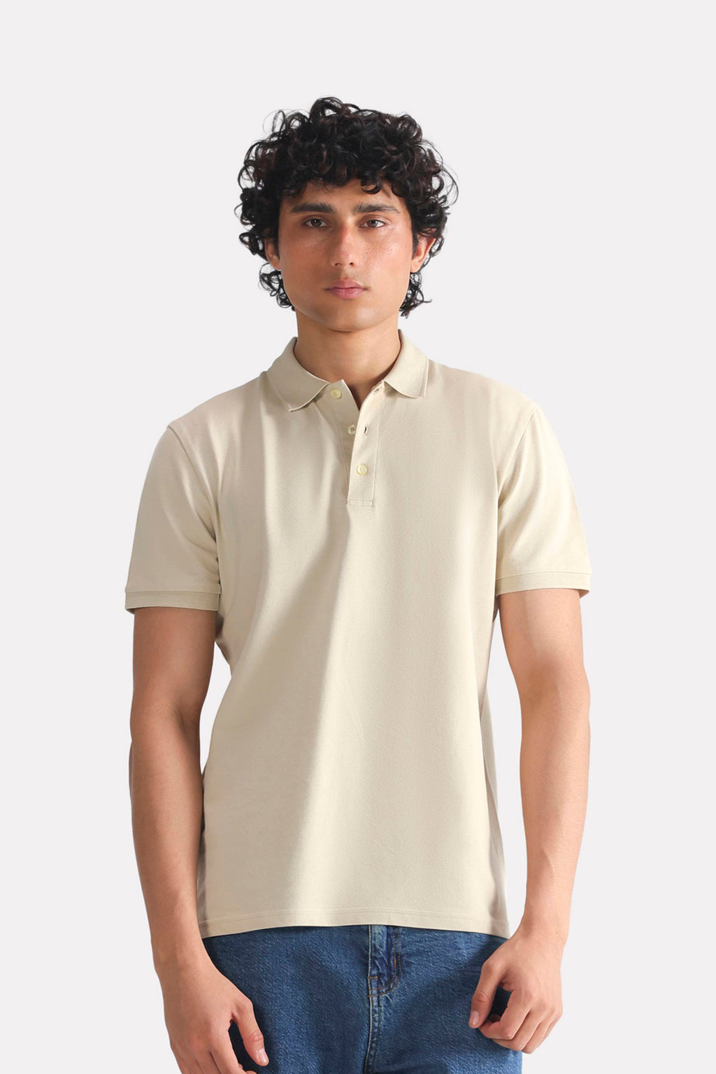 Beige (sand) micro-textured cotton pique polo, worn by a model, by SOLA Pakistan.