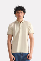 Beige (sand) micro-textured cotton pique polo, worn by a model, by SOLA Pakistan.