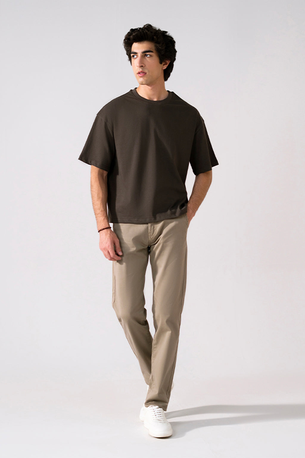 Beige satin straight-fit chino in cotton, worn by a model, by SOLA Pakistan.