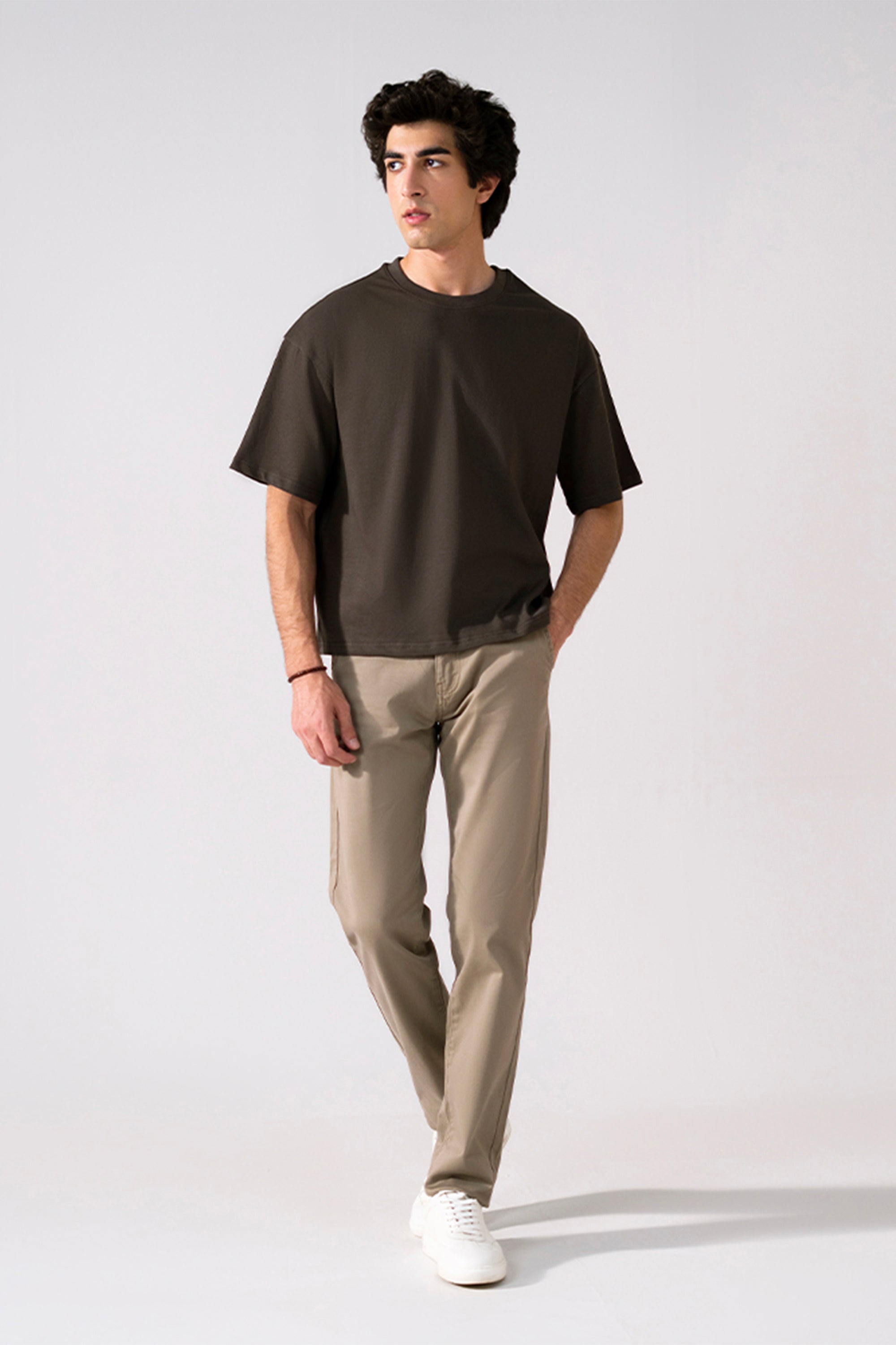 Beige satin straight-fit chino in cotton, worn by a model, by SOLA Pakistan.