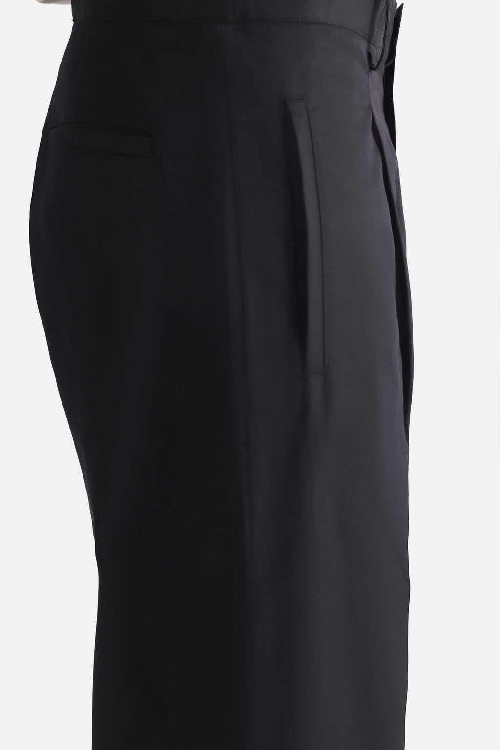 Flat lay of the black barrel-leg pleated trouser, by SOLA Pakistan.