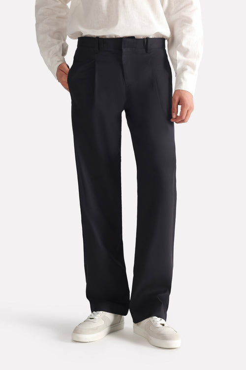 Black barrel-leg pleated trouser, full styled look, by SOLA Pakistan.