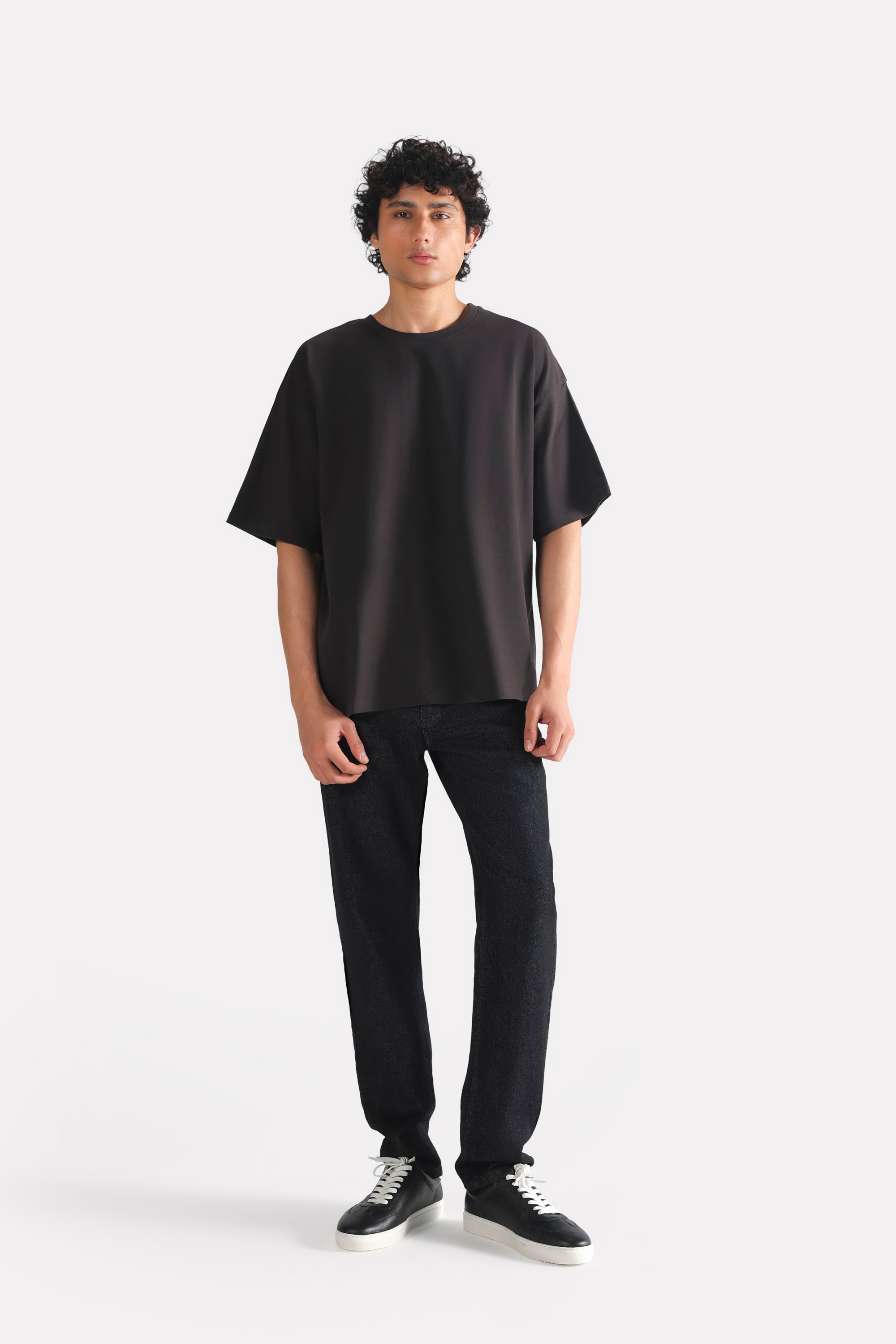 Close-up detail on the black drop shoulder cotton t-shirt, by SOLA Pakistan.