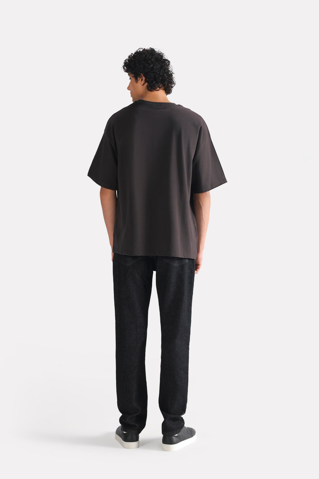 Flat lay of the black drop shoulder cotton t-shirt, by SOLA Pakistan.
