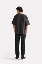 Flat lay of the black drop shoulder cotton t-shirt, by SOLA Pakistan.