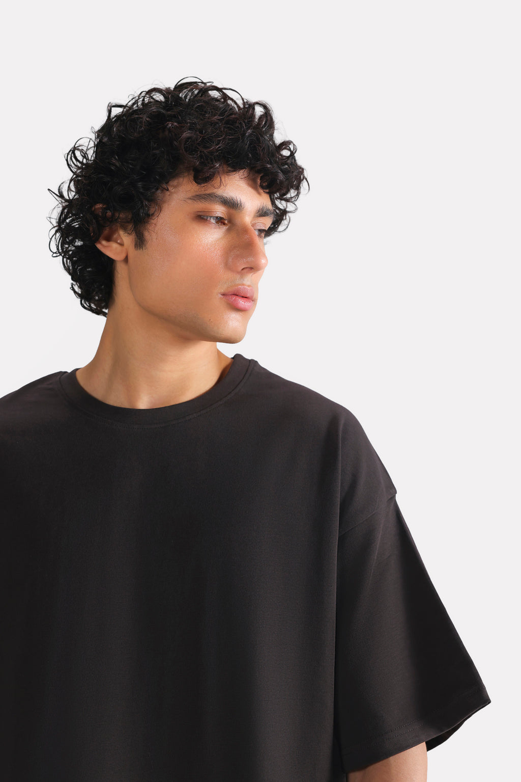 Black drop shoulder cotton t-shirt shown in a styled fit, by SOLA Pakistan.