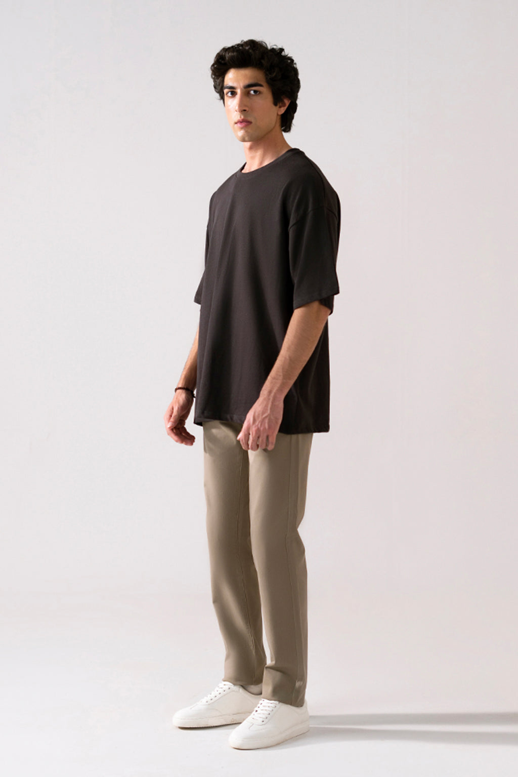 Close-up detail on the black heavy weight cropped t-shirt, by SOLA Pakistan.