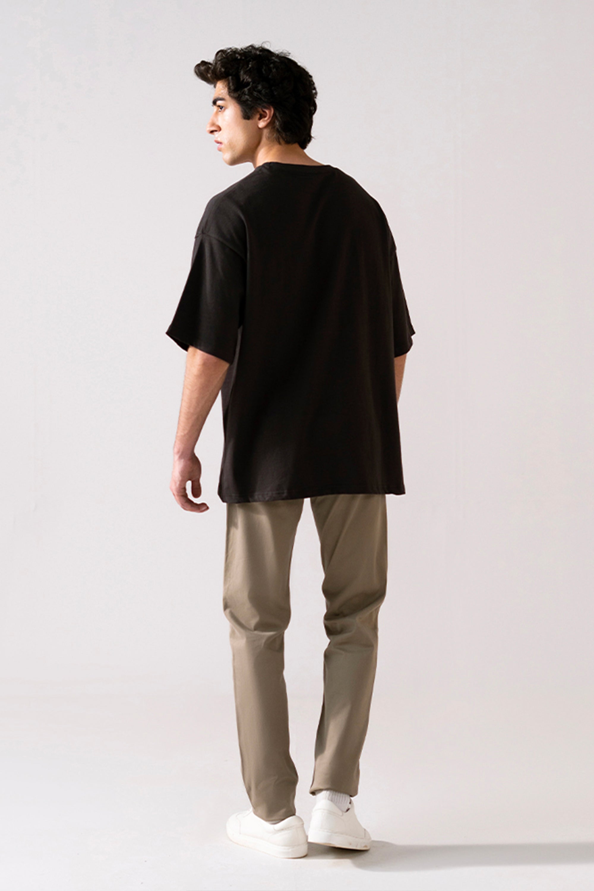 Flat lay of the black heavy weight cropped t-shirt, by SOLA Pakistan.