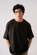 Black heavy weight cropped t-shirt in cotton, worn by a model, by SOLA Pakistan.