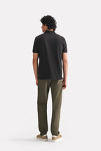 Black micro-textured cotton pique polo shown in a styled fit, by SOLA Pakistan.