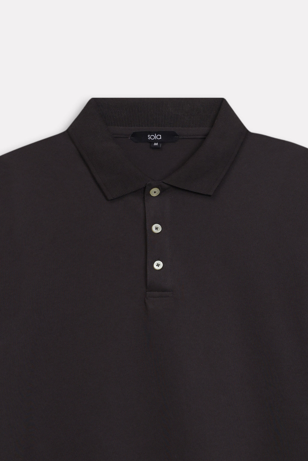 Texture and fabric detail, black micro-textured cotton pique polo, by SOLA Pakistan.