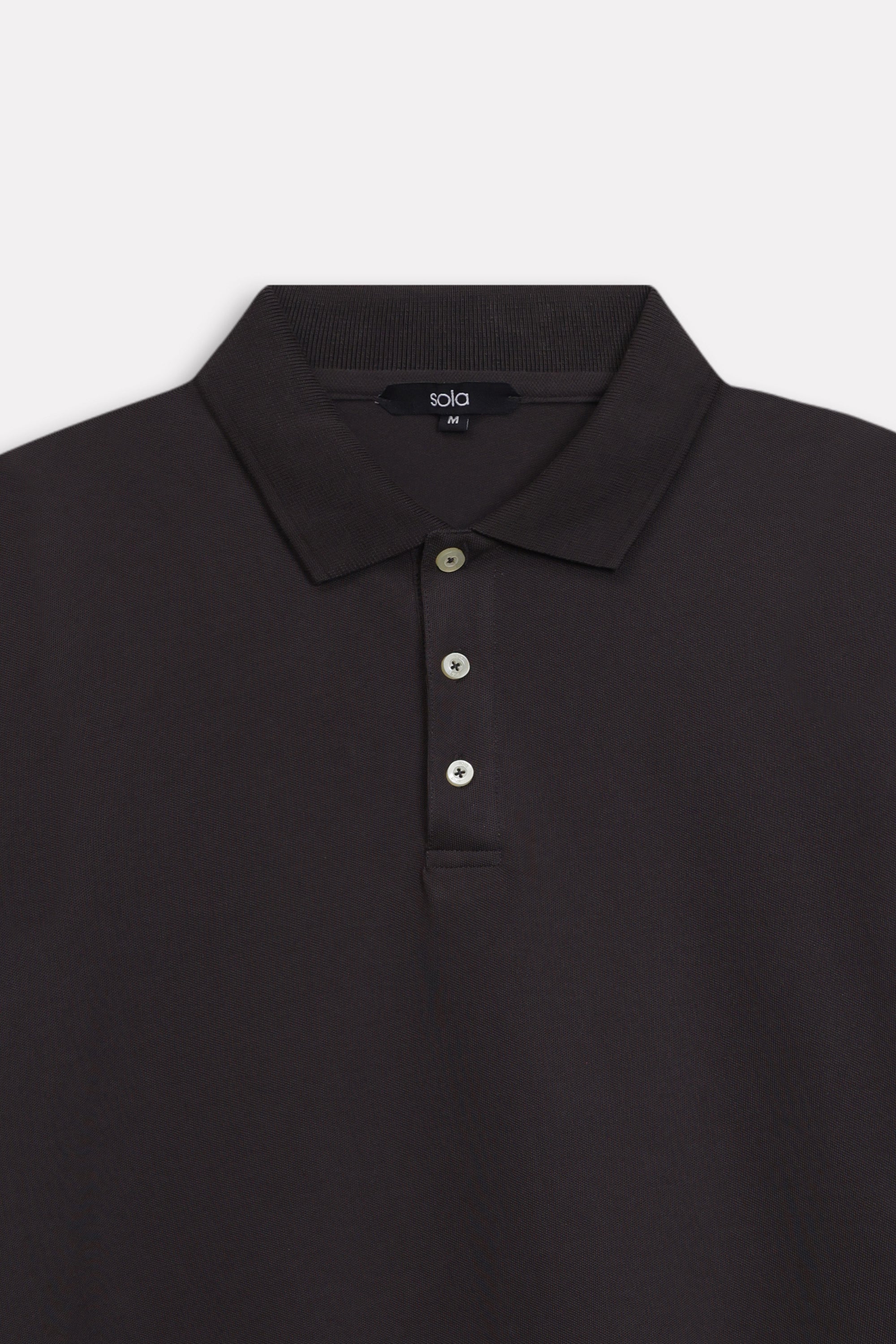 Texture and fabric detail, black micro-textured cotton pique polo, by SOLA Pakistan.
