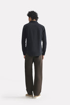 Flat lay of the black regular fit cotton shirt, by SOLA Pakistan.