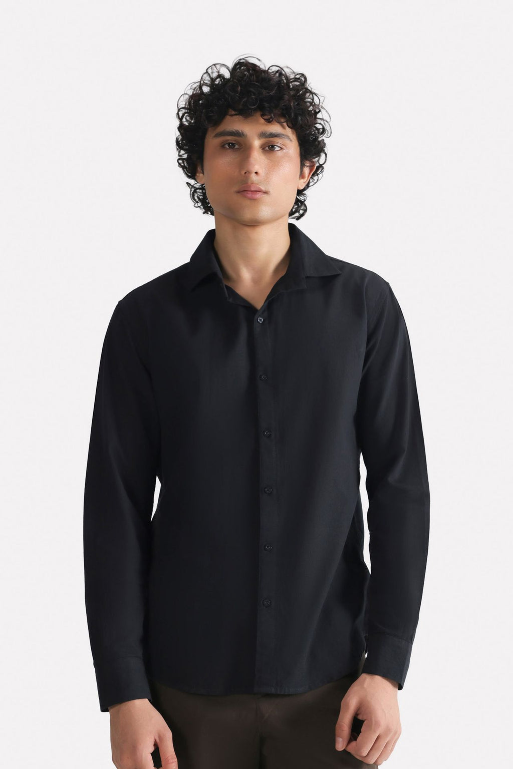 Black regular fit cotton shirt, worn by a model, by SOLA Pakistan.