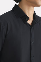 Black regular fit cotton shirt shown in a styled fit, by SOLA Pakistan.