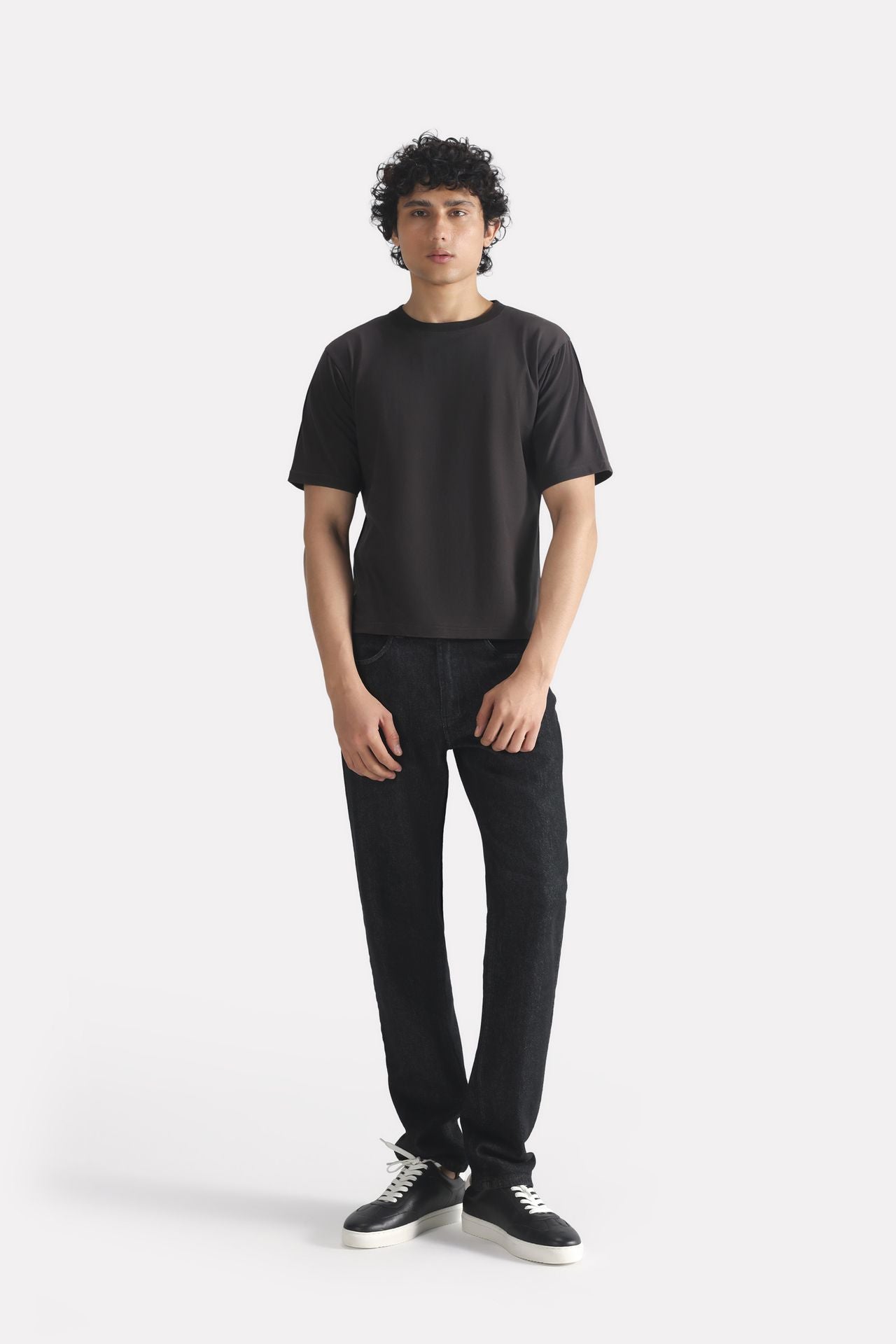 Close-up detail on the black regular fit crew neck t-shirt, by SOLA Pakistan.