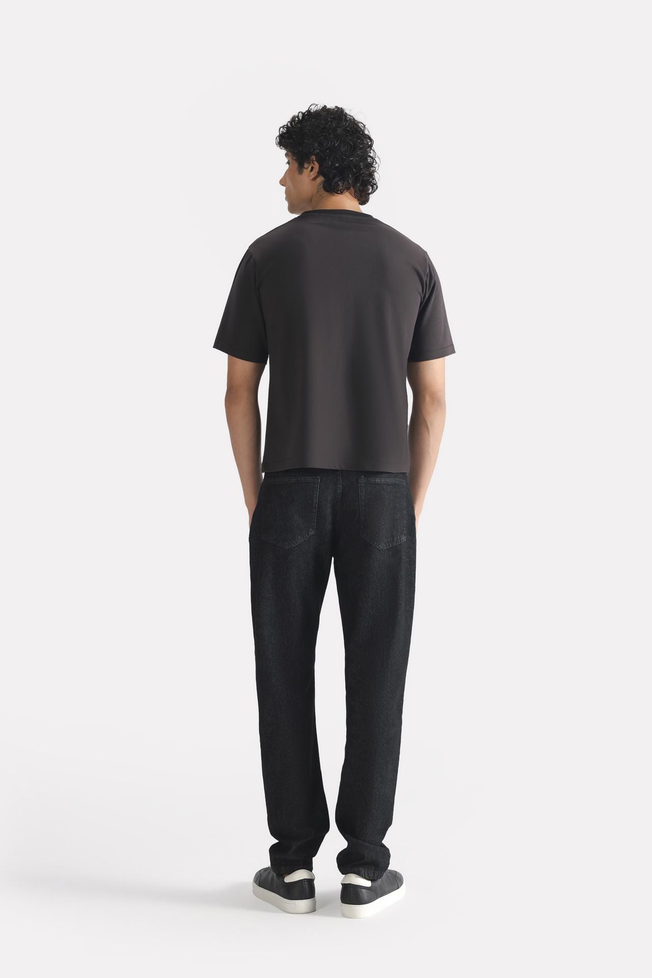 Flat lay of the black regular fit crew neck t-shirt, by SOLA Pakistan.