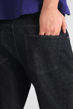 Black regular fit jean shown in a styled fit, by SOLA Pakistan.
