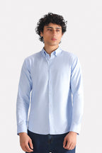 Blue slim fit textured oxford shirt in cotton, worn by a model, by SOLA Pakistan.