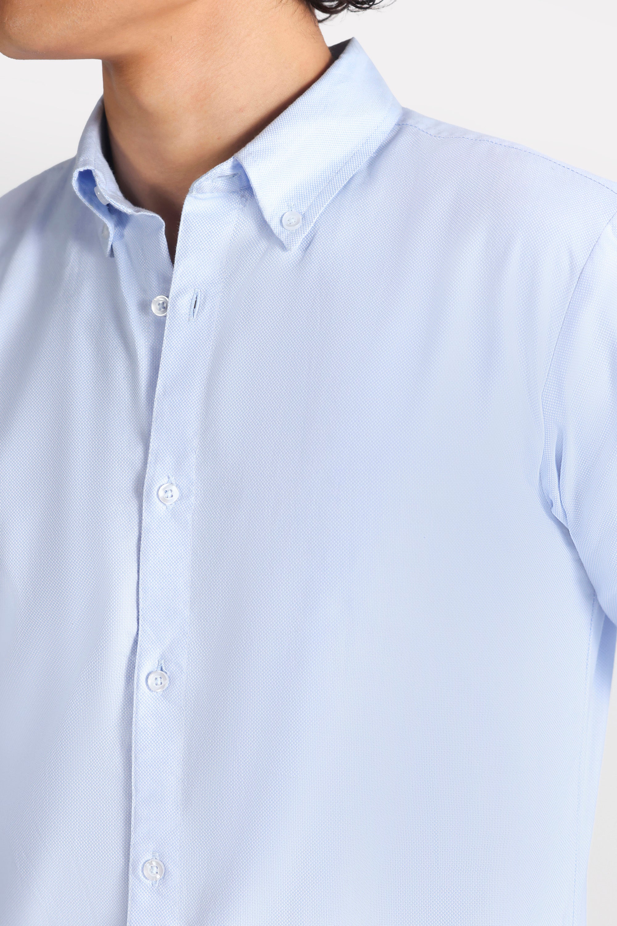 Blue slim fit textured oxford shirt shown in a styled fit, by SOLA Pakistan.