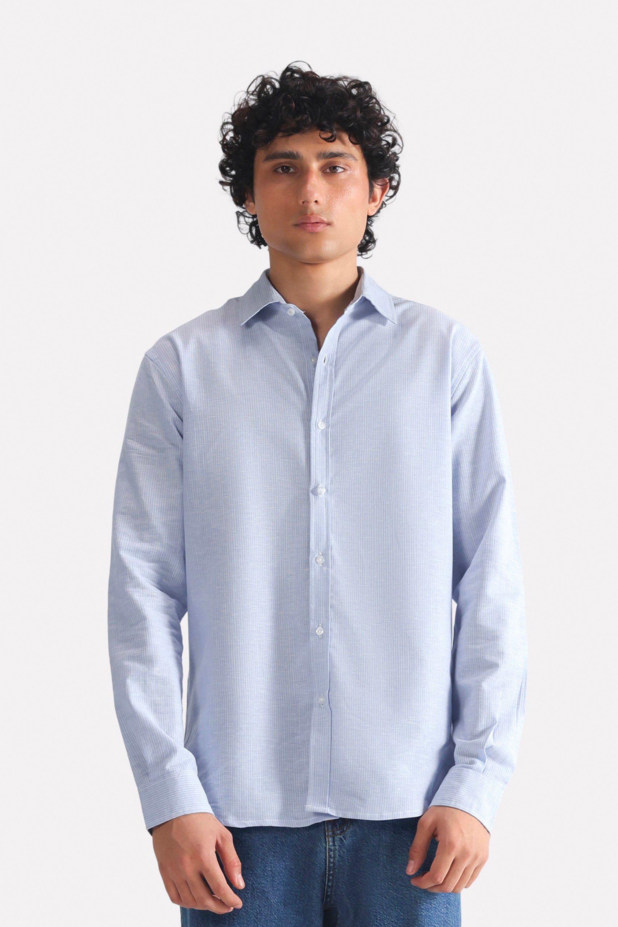 Blue stripe relaxed fit striped shirt in cotton-linen blend, worn by a model, by SOLA Pakistan.