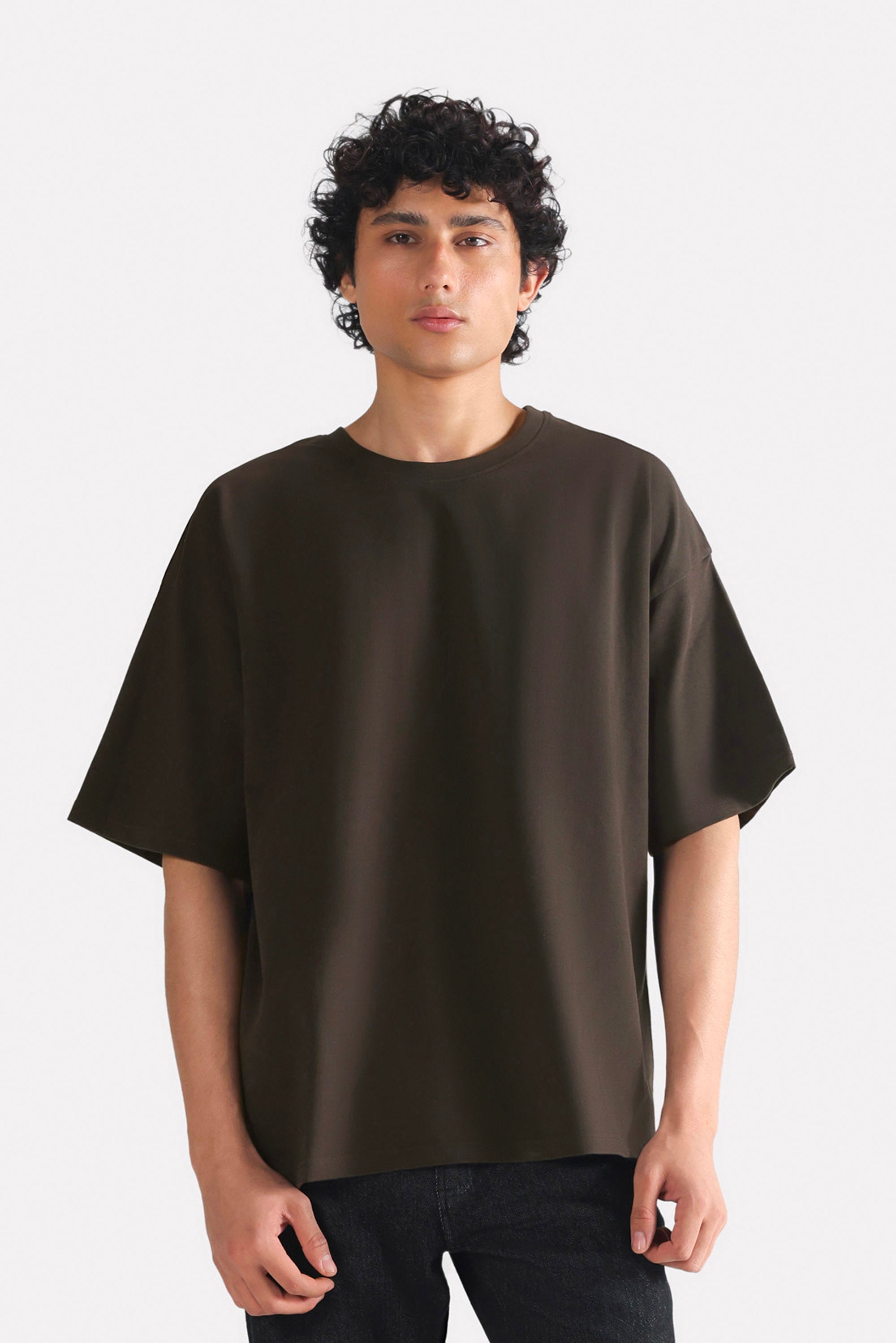 Brown drop shoulder cotton t-shirt, worn by a model, by SOLA Pakistan.