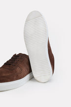Close-up detail on the brown essence suede trainer, by SOLA Pakistan.