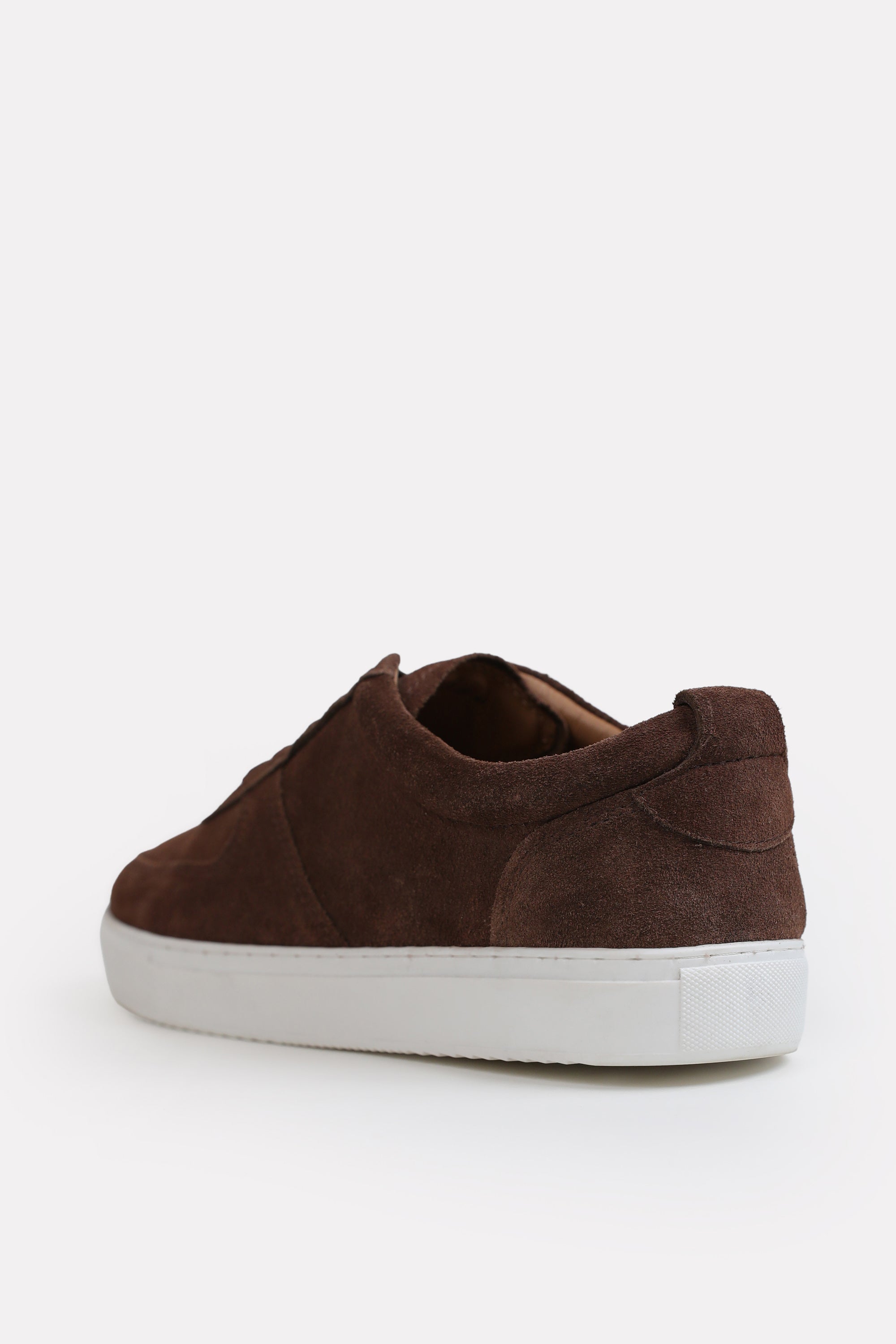 Flat lay of the brown essence suede trainer, by SOLA Pakistan.