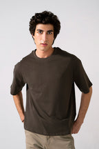 Brown heavy weight cropped t-shirt in cotton, worn by a model, by SOLA Pakistan.