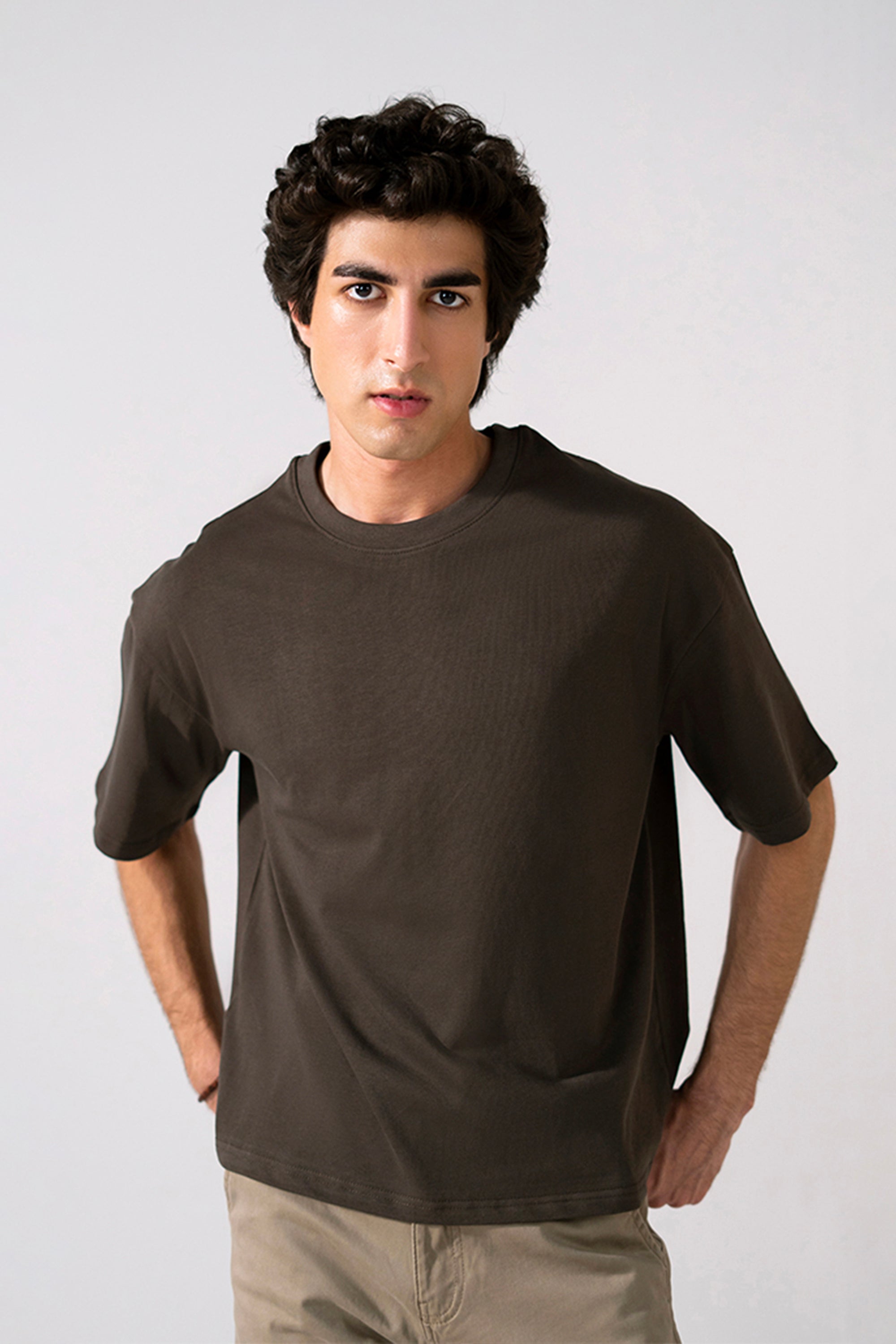 Brown heavy weight cropped t-shirt in cotton, worn by a model, by SOLA Pakistan.