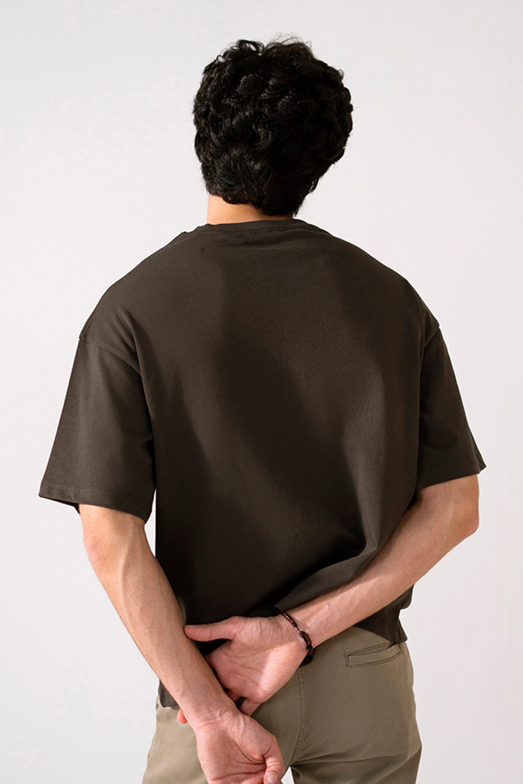 Brown heavy weight cropped t-shirt shown in a styled fit, by SOLA Pakistan.