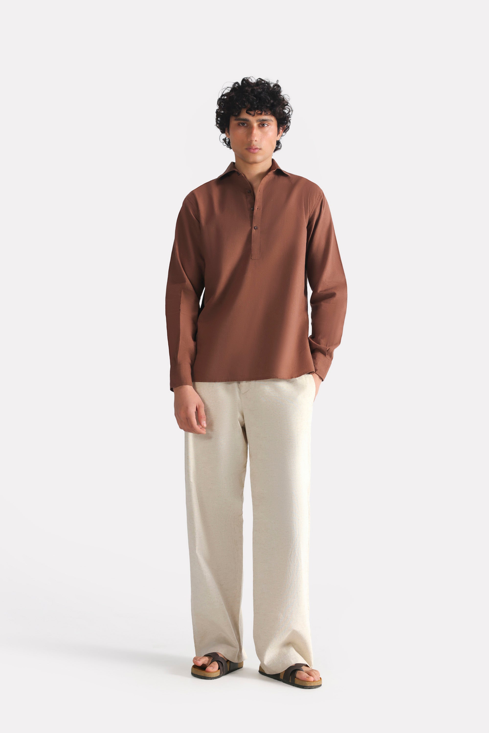 Close-up detail on the chocolate brown pop over half-placket shirt, by SOLA Pakistan.