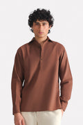 Chocolate brown pop over half-placket shirt in cotton-linen blend, worn by a model, by SOLA Pakistan.