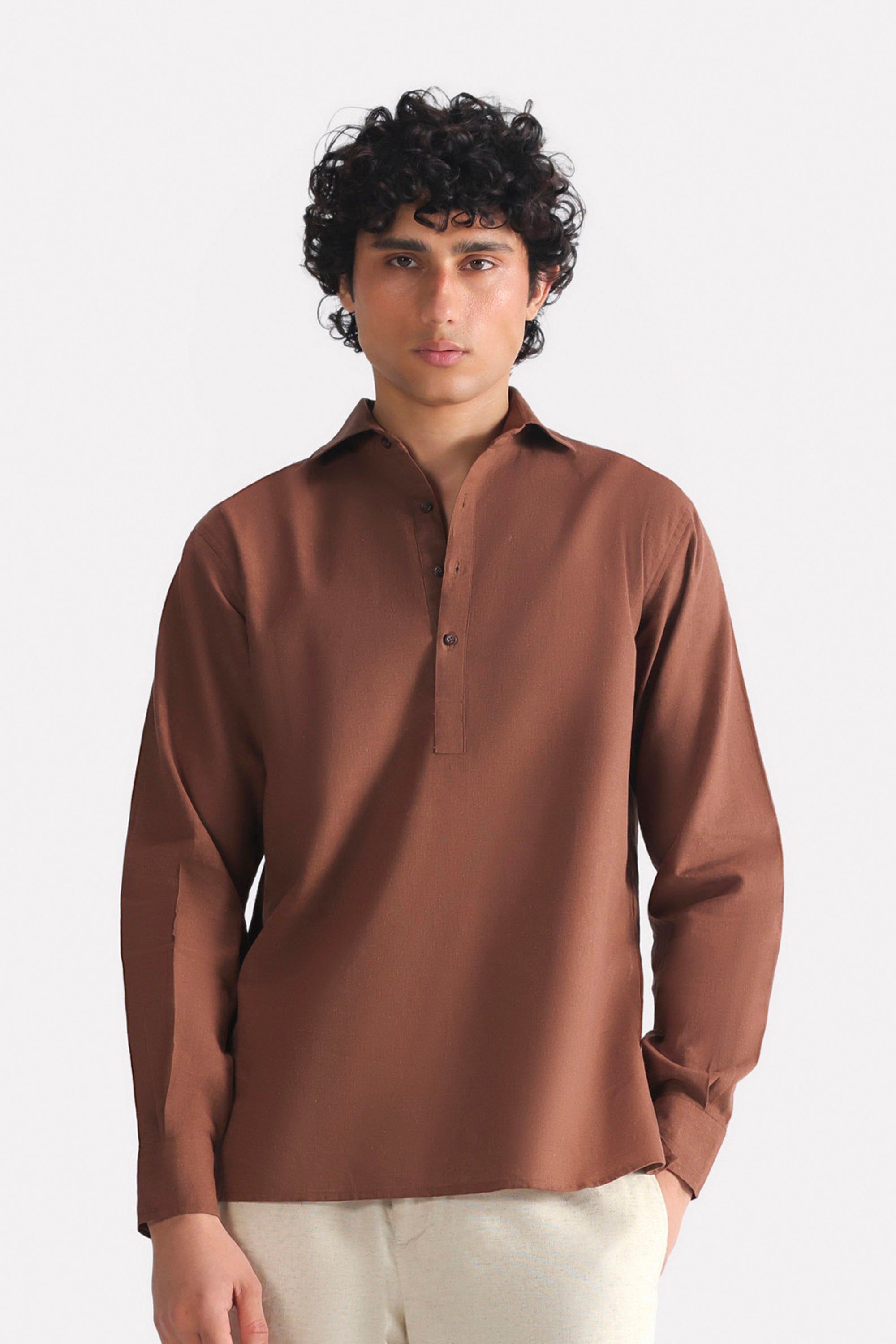 Chocolate brown pop over half-placket shirt in cotton-linen blend, worn by a model, by SOLA Pakistan.