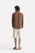 Flat lay of the chocolate brown premium cotline shirt, by SOLA Pakistan.