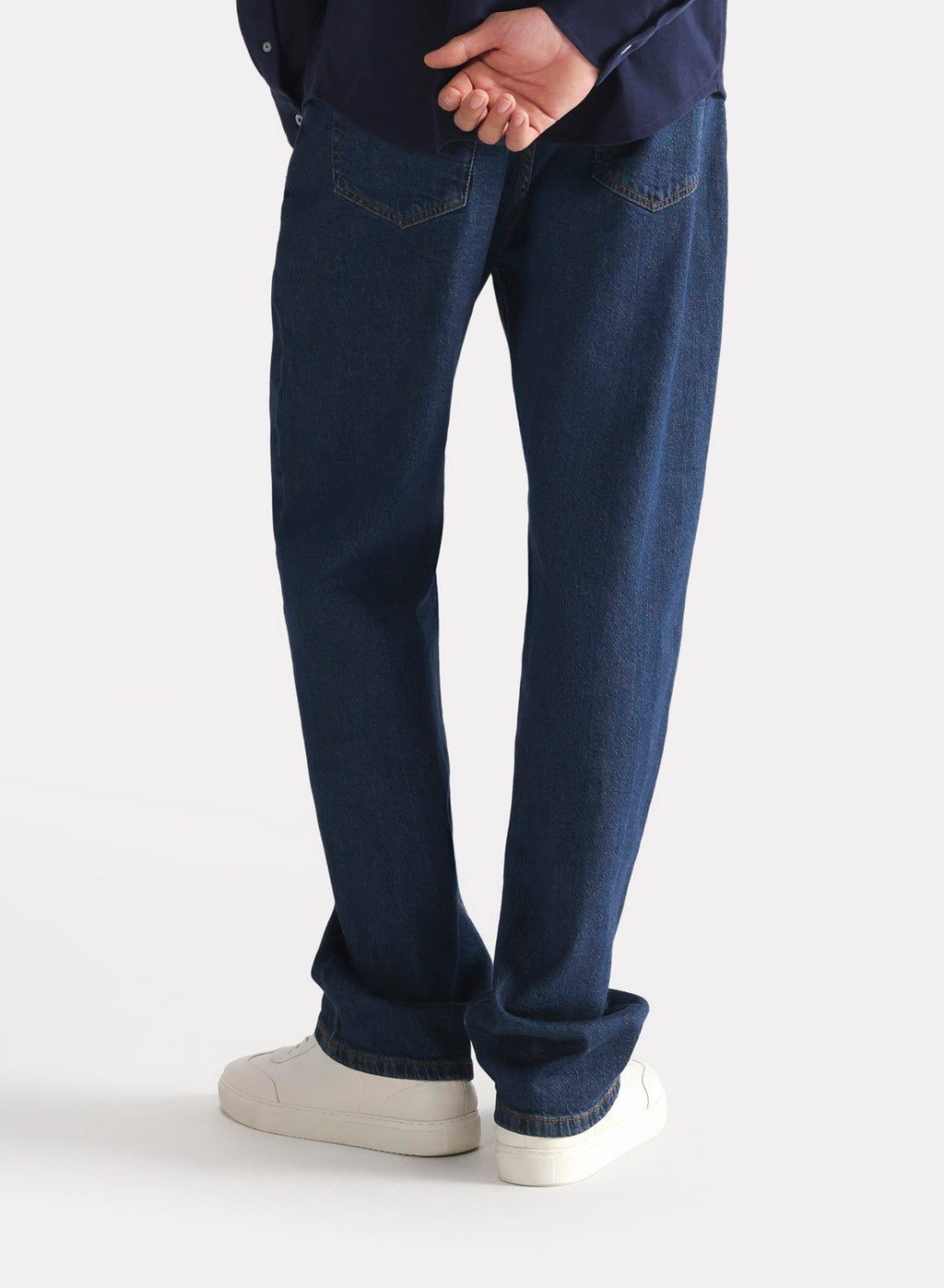 Close-up detail on the dark blue loose fit jeans, by SOLA Pakistan.