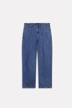 Flat lay of the dark blue loose fit jeans, by SOLA Pakistan.