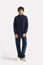 Dark blue loose fit jeans in cotton, worn by a model, by SOLA Pakistan.