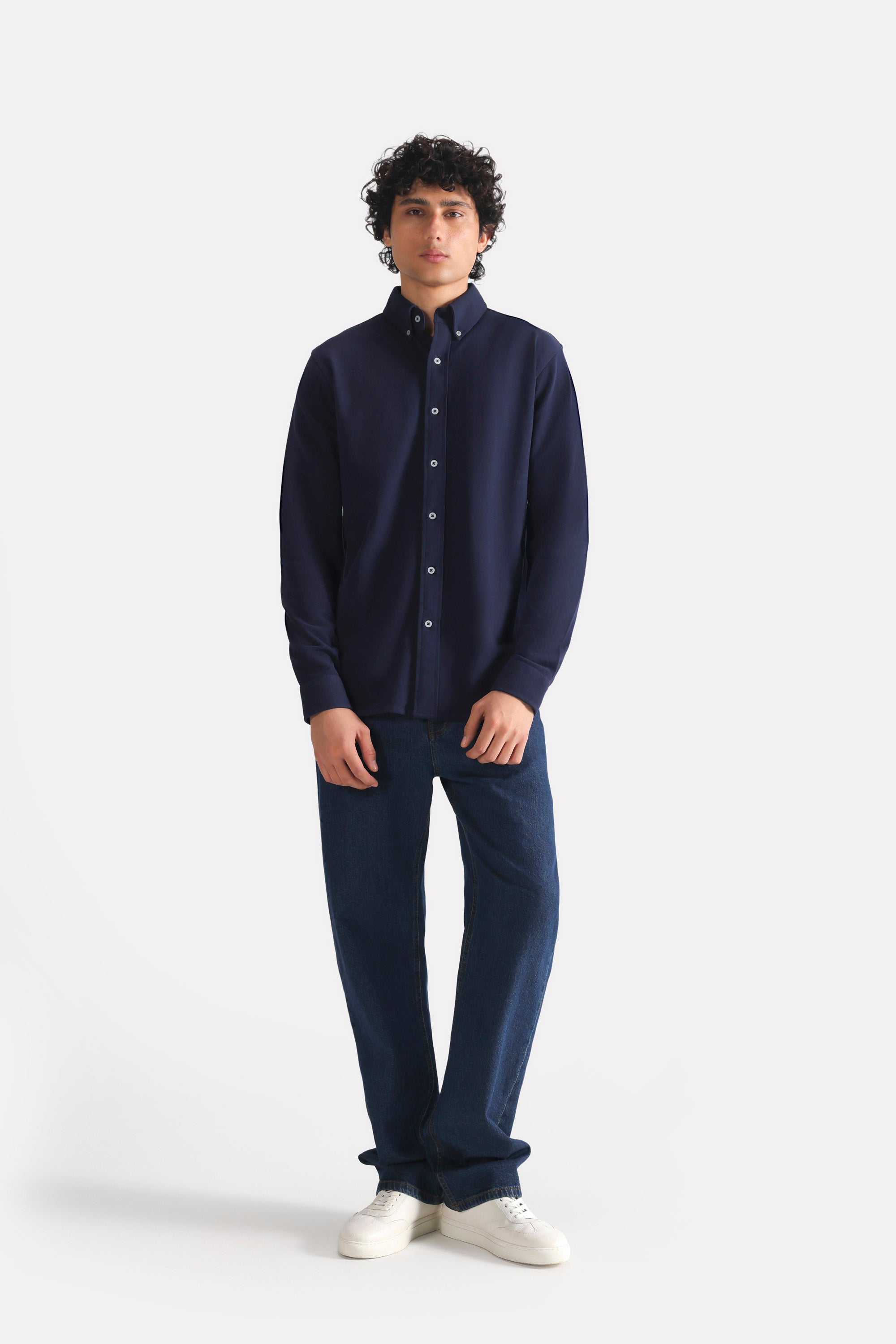 Dark blue loose fit jeans in cotton, worn by a model, by SOLA Pakistan.